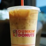 Dunkin' large iced coffee served with a straw.